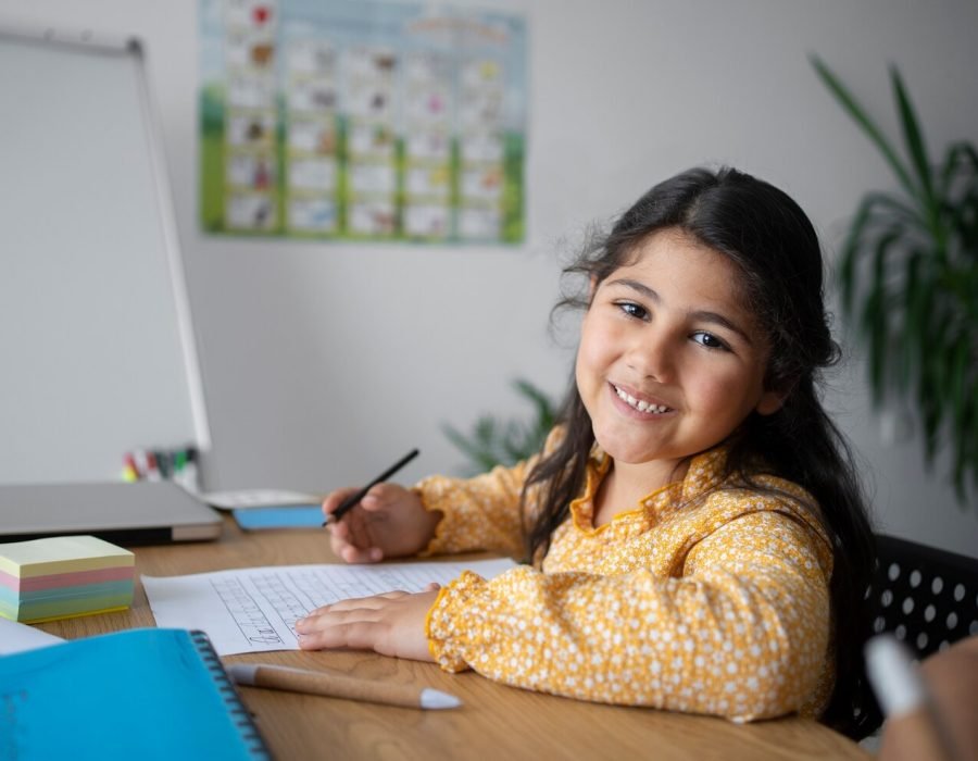 medium-shot-smiley-girl-learning-english_23-2149455195